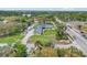 Aerial view of the expansive property with a long driveway, solar panels, and lush landscaping in a desirable location at 5800 Spruce Creek Woods Dr, Port Orange, FL 32127