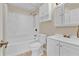 Full bathroom with a white shower-tub, toilet, and vanity with storage at 5800 Spruce Creek Woods Dr, Port Orange, FL 32127