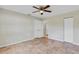 Large bedroom with multiple closets, neutral paint, tile flooring, and a ceiling fan at 5800 Spruce Creek Woods Dr, Port Orange, FL 32127