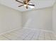 A bedroom with tile flooring, neutral paint, ceiling fan, and natural light at 5800 Spruce Creek Woods Dr, Port Orange, FL 32127