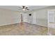 Large bedroom with neutral walls, tile flooring, and access to ensuite bathroom and closet at 5800 Spruce Creek Woods Dr, Port Orange, FL 32127