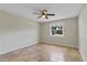 Bedroom with a ceiling fan, neutral paint, and a window overlooking the yard at 5800 Spruce Creek Woods Dr, Port Orange, FL 32127