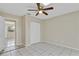 Bedroom with tile flooring, ceiling fan, natural light, and a closet at 5800 Spruce Creek Woods Dr, Port Orange, FL 32127