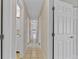Hallway with multiple doors and tile flooring throughout the home at 5800 Spruce Creek Woods Dr, Port Orange, FL 32127