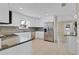 Bright kitchen with white cabinets, granite countertops, stainless steel appliances, and a mosaic backsplash at 5800 Spruce Creek Woods Dr, Port Orange, FL 32127