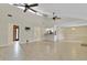 Open concept living room featuring tile flooring, high ceilings, and skylights at 5800 Spruce Creek Woods Dr, Port Orange, FL 32127