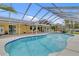 Relaxing outdoor pool with a screened enclosure and ample space for entertaining and enjoying the weather at 5800 Spruce Creek Woods Dr, Port Orange, FL 32127