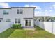 A fenced-in backyard with a well maintained lawn and a covered patio area at 597 Madison Dr, Davenport, FL 33837