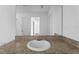 Bathroom featuring granite vanity, modern faucet, and view into another room at 597 Madison Dr, Davenport, FL 33837