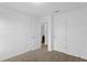 Bright bedroom features neutral carpet, white walls, two doors, and an ensuite entrance at 597 Madison Dr, Davenport, FL 33837