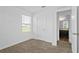 Bright carpeted bedroom featuring a window, a closet, and an ensuite bathroom entrance at 597 Madison Dr, Davenport, FL 33837