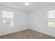 Bedroom featuring plush carpet, dual windows bringing in natural light, and white walls at 597 Madison Dr, Davenport, FL 33837
