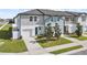 Well-maintained townhome featuring an attached garage and tidy front lawn at 597 Madison Dr, Davenport, FL 33837