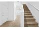 Bright hallway with carpeted stairs leading up to the next level at 597 Madison Dr, Davenport, FL 33837