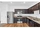 Modern kitchen with stainless steel appliances and granite countertops at 597 Madison Dr, Davenport, FL 33837