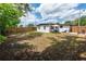 Spacious backyard with a patio lounge set, go-kart and grass perfect for activities at 620 E Church Ave, Longwood, FL 32750