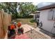 Backyard featuring a wooden fence, patio with a small lounge set, and a go-kart at 620 E Church Ave, Longwood, FL 32750