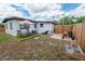 Backyard features a wooden fence, patio with a lounge set, and lush landscaping at 620 E Church Ave, Longwood, FL 32750