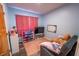 Cozy bedroom featuring pink walls, a mounted television, and a comfortable gray sofa at 620 E Church Ave, Longwood, FL 32750