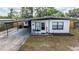 Charming single story home featuring new landscaping, a front porch, and a covered carport at 620 E Church Ave, Longwood, FL 32750
