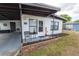 Welcoming front porch with brick accents and a cozy seating area at 620 E Church Ave, Longwood, FL 32750