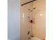 This bathroom includes a tiled shower with shower head, soap rack and mounted faucet at 620 E Church Ave, Longwood, FL 32750