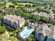 Aerial view of condo complex with swimming pool and community amenities at 6685 Queens Borough Ave # 202, Orlando, FL 32835
