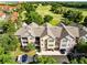 Aerial view of a condo complex near a golf course and lush landscaping at 6685 Queens Borough Ave # 202, Orlando, FL 32835