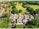 Aerial view of a condo complex near a golf course and lush landscaping at 6685 Queens Borough Ave # 202, Orlando, FL 32835
