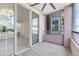 Enclosed balcony with ceiling fan offers a nice outdoor space overlooking the complex at 6685 Queens Borough Ave # 202, Orlando, FL 32835