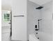 Modern bathroom featuring stylish tiling, black fixtures and hardware, and a soaking tub at 6685 Queens Borough Ave # 202, Orlando, FL 32835
