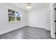 Bedroom featuring a window, hardwood style floors, and a door at 6685 Queens Borough Ave # 202, Orlando, FL 32835