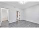 A bright bedroom with hardwood style floors and an adjoining bathroom at 6685 Queens Borough Ave # 202, Orlando, FL 32835