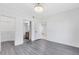 A large bedroom featuring hardwood style floors, a door and two entryways at 6685 Queens Borough Ave # 202, Orlando, FL 32835