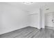 An empty bedroom with hardwood style floors and a closet at 6685 Queens Borough Ave # 202, Orlando, FL 32835