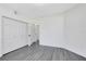 A bedroom featuring two closets, hardwood style floors and a door to the bathroom at 6685 Queens Borough Ave # 202, Orlando, FL 32835
