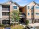 Exterior shot of the building highlighting the architecture and surrounding landscape at 6685 Queens Borough Ave # 202, Orlando, FL 32835