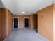 Building hallway with two black doors, neutral paint, and a concrete floor at 6685 Queens Borough Ave # 202, Orlando, FL 32835