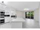 Bright kitchen featuring a large island with bar seating and stylish black splash at 6685 Queens Borough Ave # 202, Orlando, FL 32835