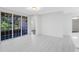 A brightly lit and open living room area featuring sleek white tile floors and ample natural light at 6685 Queens Borough Ave # 202, Orlando, FL 32835