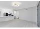 Open-concept living space showcasing modern lighting and an adjacent kitchen area at 6685 Queens Borough Ave # 202, Orlando, FL 32835