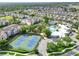 Aerial view of community pool and tennis courts surrounded by houses at 8118 Fan Palm Way, Kissimmee, FL 34747