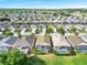 Neighborhood of homes with screened-in pools surrounded by well-kept lawns and green trees at 8118 Fan Palm Way, Kissimmee, FL 34747
