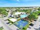 Aerial view of the community clubhouse and pool, surrounded by lush landscaping at 8118 Fan Palm Way, Kissimmee, FL 34747