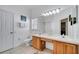 Bright bathroom with dual sinks, a large mirror, and a shower/tub combo at 8118 Fan Palm Way, Kissimmee, FL 34747