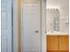 Shot of a bathroom through a doorway showcasing the vanity and mirror at 8118 Fan Palm Way, Kissimmee, FL 34747