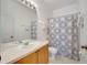 Bathroom with a single sink, large mirror, tile floor, and shower/tub at 8118 Fan Palm Way, Kissimmee, FL 34747