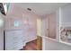 bedroom with laminate flooring, dresser, wall decor, and open doorway at 8118 Fan Palm Way, Kissimmee, FL 34747