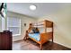 Cozy bedroom featuring a wooden bunk bed, TV, and wood-look laminate flooring at 8118 Fan Palm Way, Kissimmee, FL 34747