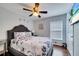 Cozy bedroom featuring a ceiling fan, nice window, and modern wall art at 8118 Fan Palm Way, Kissimmee, FL 34747